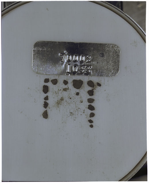 Color photograph of Apollo 17 Sample(s) 70002,1033; Processing photograph displaying a group of >1 MM Core Fines.