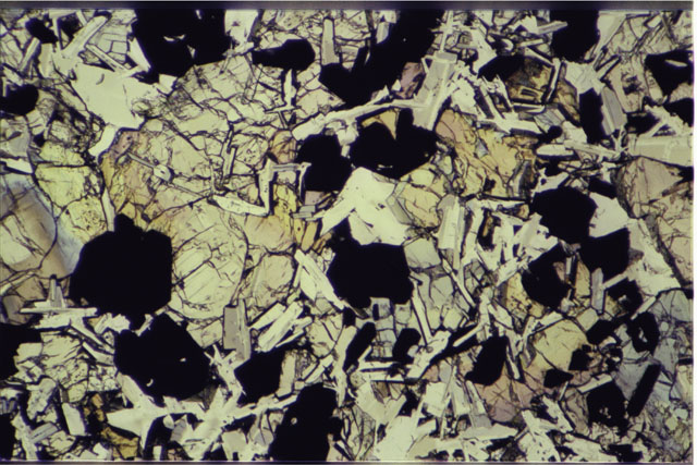 Color photograph of Apollo 11 Sample(s) 10003,152; 2.7 MM Thin Section photograph using transmitted light.