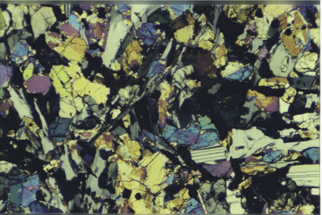 Color 2.7 mm Thin Section photograph of Apollo 12 Sample(s) 12063,5 using cross nichols light.