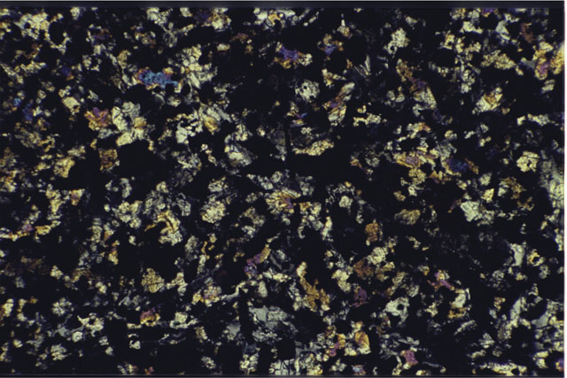 Color photograph of Apollo 11 Sample(s) 10049,32; 0.69 MM Thin Section photograph using cross nichols light.