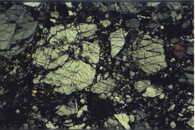 Color photograph of Apollo 16 Sample(s) 60025,21; 2.7 MM Thin Section photograph using cross nichols light.