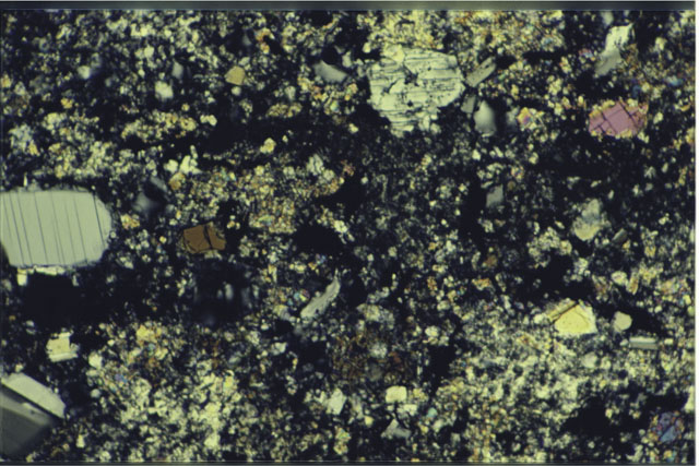 Color photograph of Apollo 17 Sample(s) 76015,9; 1.4 MM Thin Section photograph using cross nichols light.