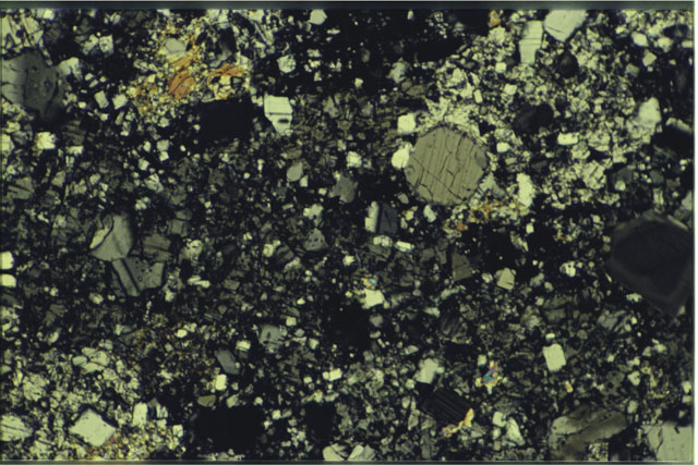 Color photograph of Apollo 16 Sample(s) 65015,13; 1.4 MM Thin Section photograph using cross nichols light.