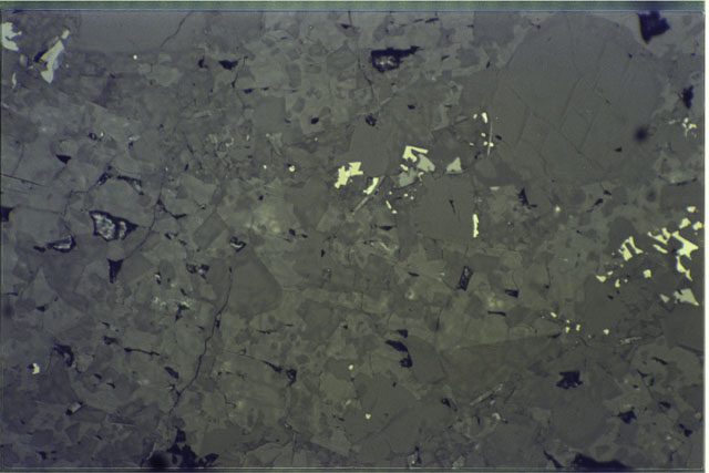 Color photograph of Apollo 16 Sample(s) 65015,13; .69 MM Thin Section photograph using reflected light.