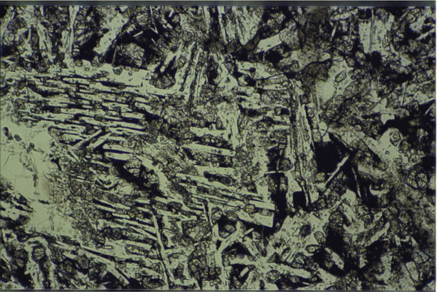 Color photograph of Apollo 16 Sample(s) 61016,220; 2.7 MM Thin Section photograph using transmitted light.