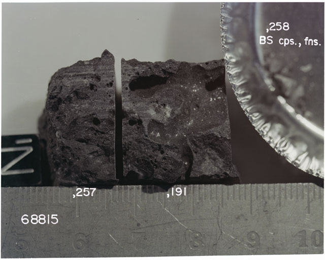 Color photograph of Apollo 16 Sample(s) 68815,257,191; Processing photograph displaying sawed surface with an orientation of N.