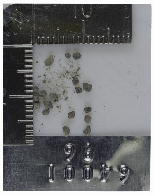 Color photograph of Apollo 16 Core Sample 64001,96; Processing photograph displaying >1 MM Core Fines .