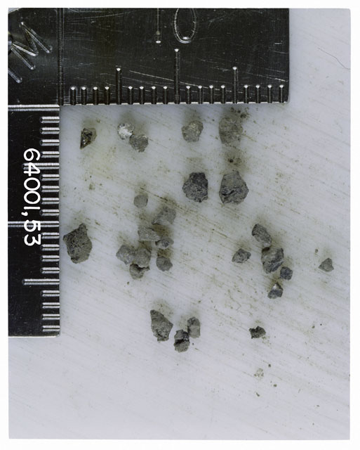 Color photograph of Apollo 16 Core Sample 64001,53; Processing photograph displaying >1 MM Core Fines .