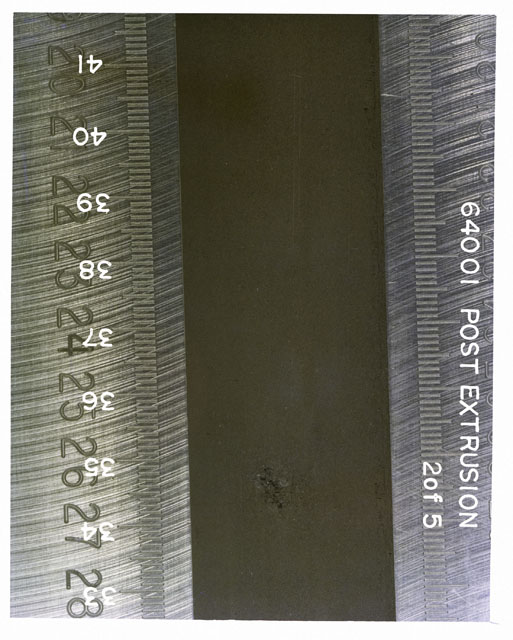 Color photograph of Apollo 16 Sample(s) 64001; 2 of 5 Processing photograph displaying post extrusion Core Tube at 33-41 cm depth.
