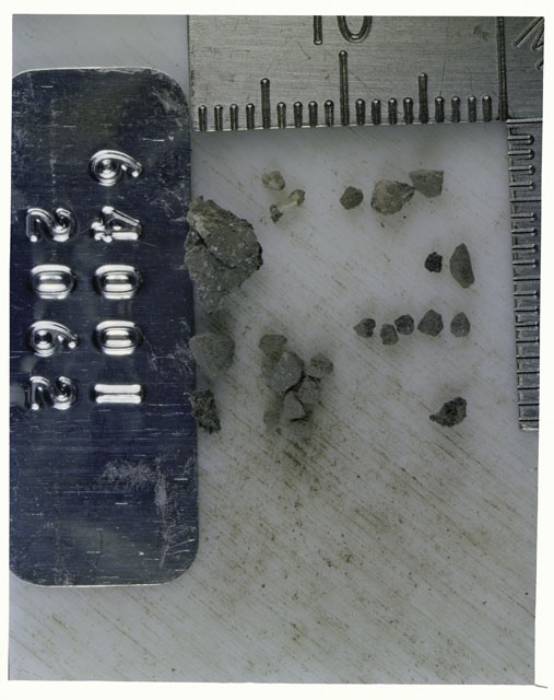Color photograph of Apollo 16 Core Sample 64001,2062; Processing photograph displaying >1 MM Core Fines .