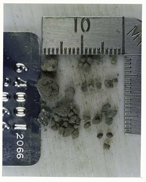 Color photograph of Apollo 16 Core Sample 64001,2066; Processing photograph displaying >1 MM Core Fines .