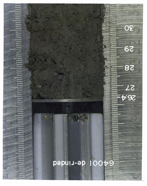 Color photograph of Apollo 16 Core Sample 64001; Processing photograph displaying 26.4-30 cm depth Core Tube derinded.