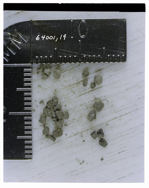 Color photograph of Apollo 16 Core Sample 64001,19; Processing photograph displaying >1 MM Core Fines .