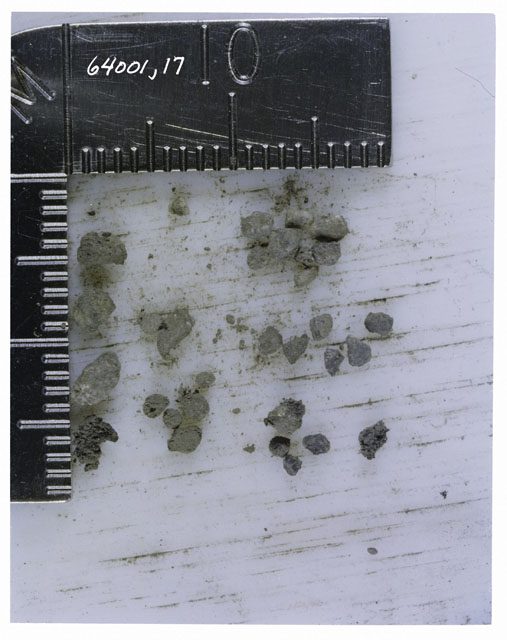 Color photograph of Apollo 16 Core Sample 64001,17; Processing photograph displaying >1 MM Core Fines .