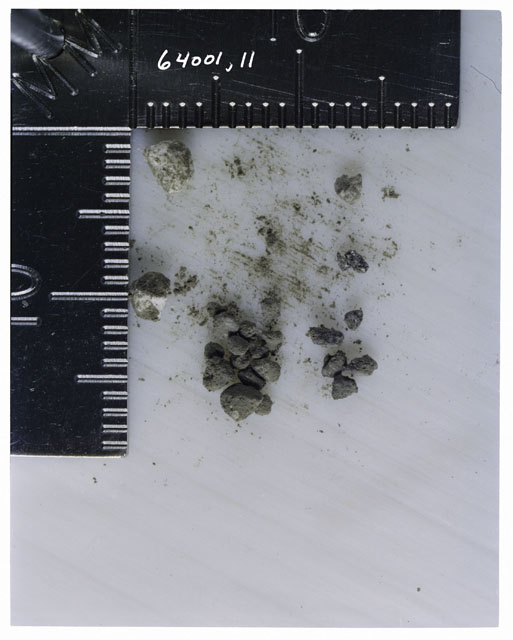 Color photograph of Apollo 16 Core Sample 64001,11; Processing photograph displaying >1 MM Core Fines .