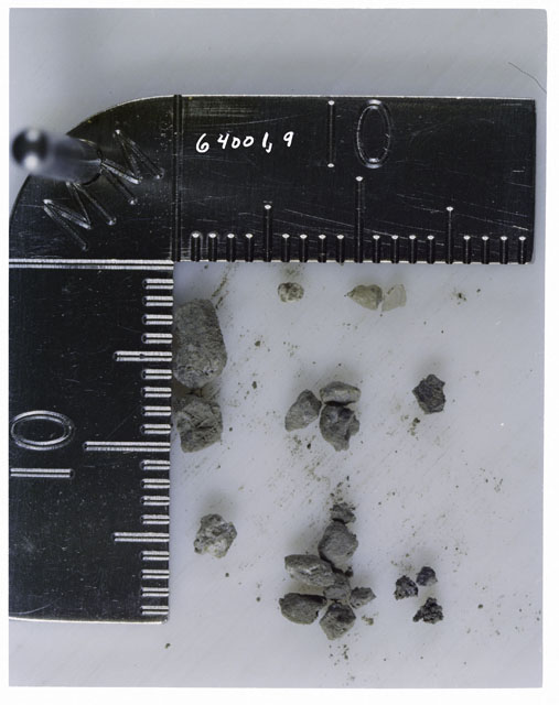 Color photograph of Apollo 16 Core Sample 64001,9; Processing photograph displaying >1 MM Core Fines .