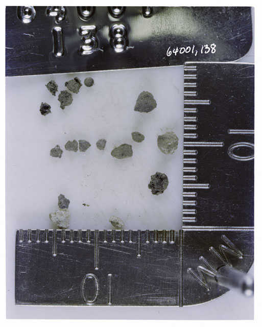 Color photograph of Apollo 16 Core Sample 64001,138; Processing photograph displaying >1 MM Core Fines .