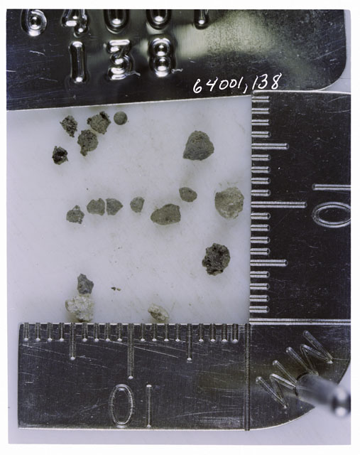 Color photograph of Apollo 16 Core Sample 64001,138; Processing photograph displaying >1 MM Core .