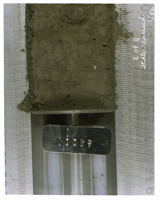 Color photograph of Apollo 16 Core Sample(s) 64001,1; 11 of 11 Processing photograph of displaying Core with scale reversed.