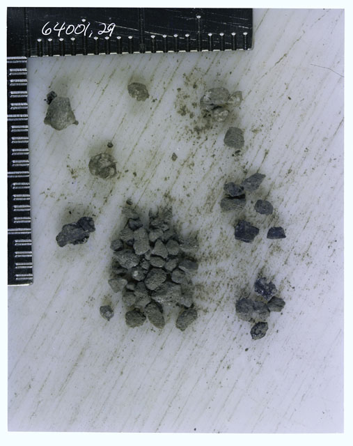 Color photograph of Apollo 16 Core Sample 64001,29; Processing photograph displaying >1 MM Core Fines .