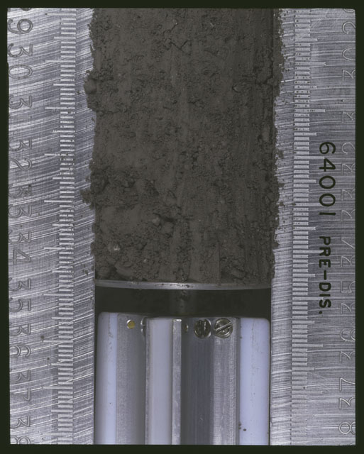 Color photograph of Apollo 16 Sample(s) 64001; 1 of 11 Processing photograph displaying pre-dissection Core at 29-35 cm depth.