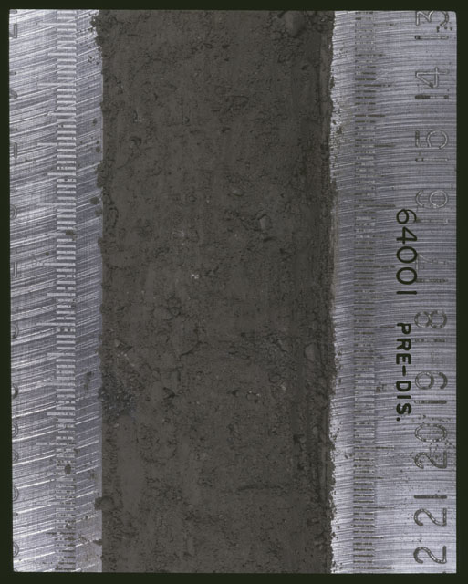 Color photograph of Apollo 16 Sample(s) 64001; 6 of 11 Processing photograph displaying pre-dissection Core at 13-22 cm depth.