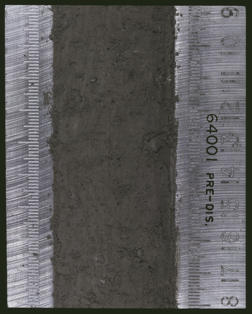 Color photograph of Apollo 16 Sample(s) 64001; 7 of 11 Processing photograph displaying pre-dissection Core at 9-18 cm depth.