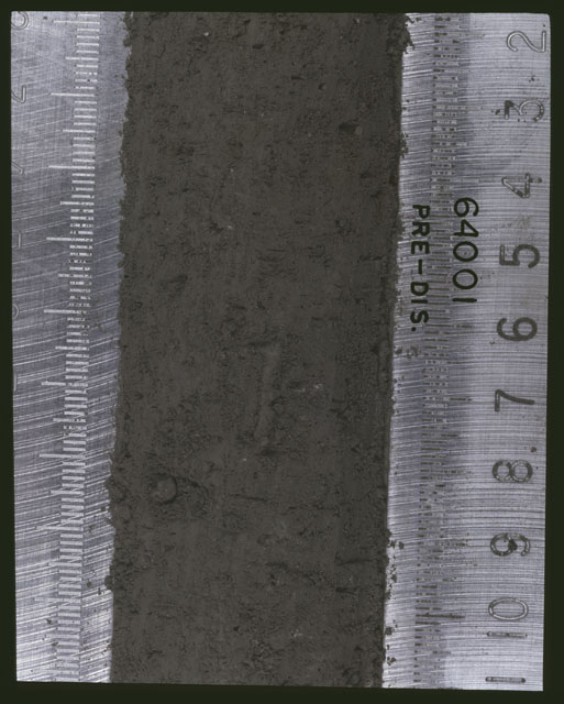 Color photograph of Apollo 16 Sample(s) 64001; 9 of 11 Processing photograph displaying pre-dissection Core at 2-11 cm depth.