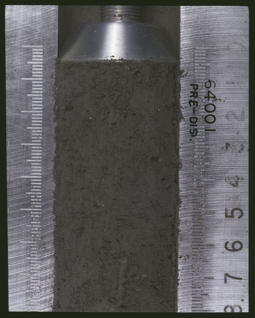 Color photograph of Apollo 16 Sample(s) 64001; 10 of 11 Processing photograph displaying pre-dissection Core at 0-4.5 cm depth.