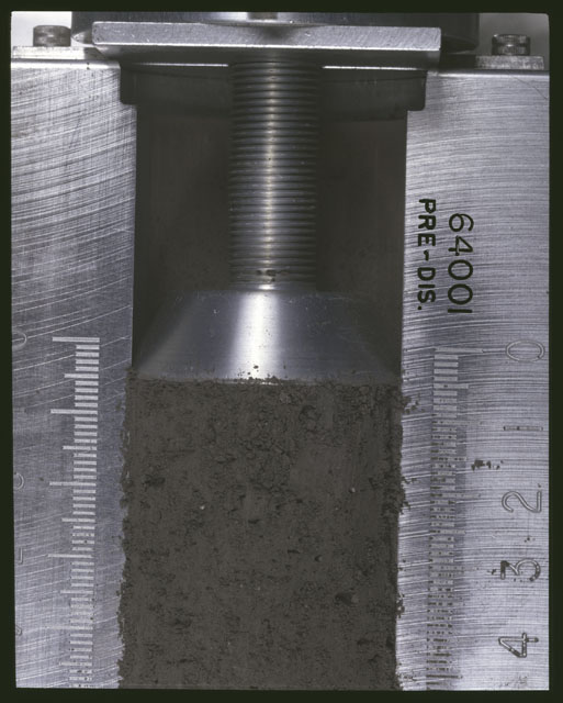 Color photograph of Apollo 16 Sample(s) 64001;Processing photograph displaying pre-dissection Core at 0-4.5 cm depth.