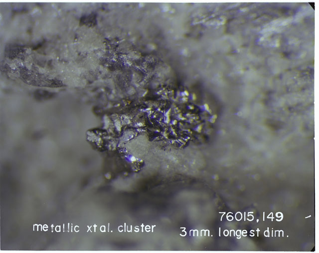 Color photograph of Apollo 17 Sample(s) 76015,149; Processing photograph displaying a close up view of a 3 mm diameter Metallic Crystal Cluster.