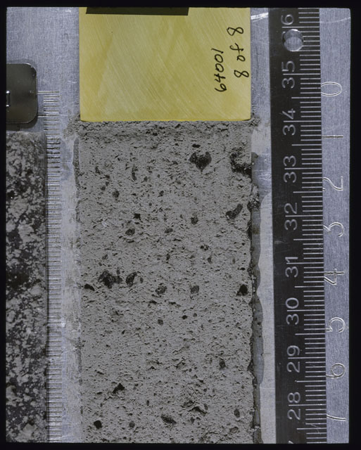 Color photograph of Apollo 16 Sample(s) 64001; 8 of 8 Processing photograph displaying post peel Core at 27.5-35 cm depth.