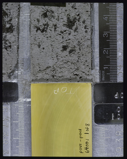 Color photograph of Apollo 16 Sample(s) 64001; 1 of 8 Processing photograph displaying post peel Core at 0-5 cm depth.