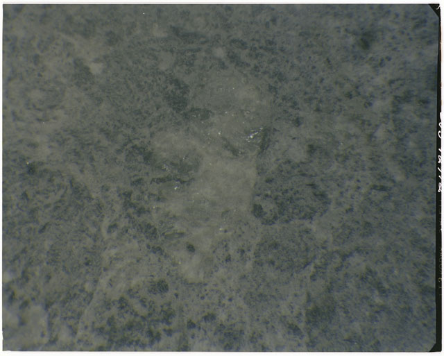 Color photograph of Apollo 14 Sample(s) 14304; Processing photograph displaying a close up of a clast.