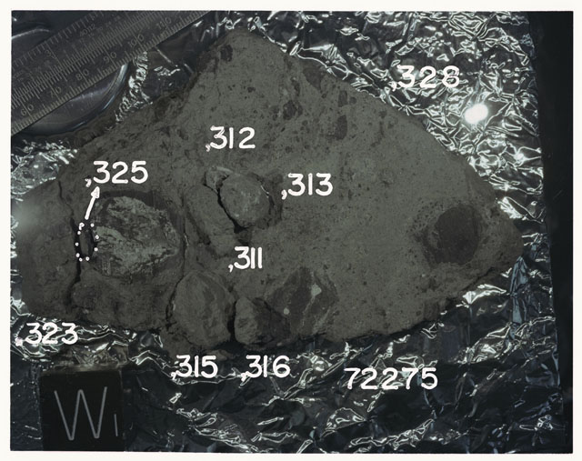 Color photograph of Apollo 17 Sample(s)72275,311-313,315,316,325; Processing photograph displaying slab reconstruction with an orientation of W.