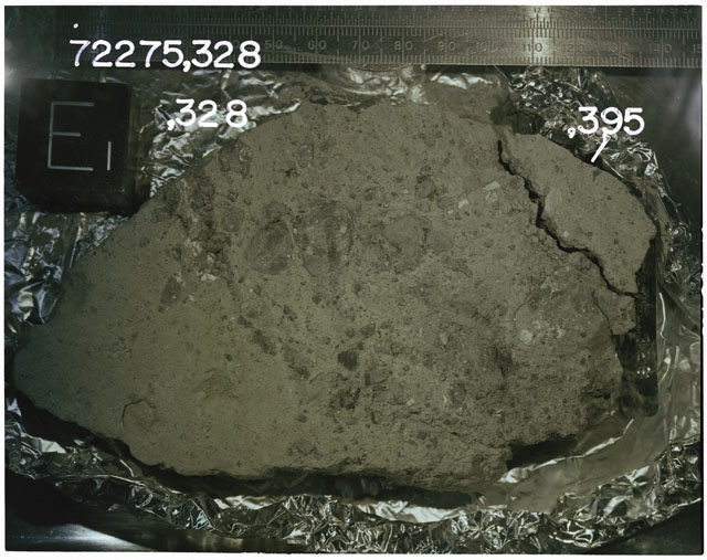 Color photograph of Apollo 17 Sample(s)72275,328,395; Processing photograph displaying slab reconstruction with an orientation of E.