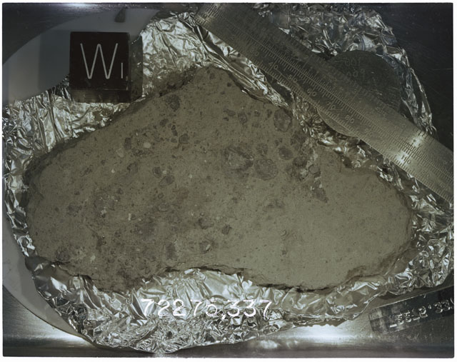 Color photograph of Apollo 17 Sample(s)72275; Processing photograph displaying slab with an orientation of W.