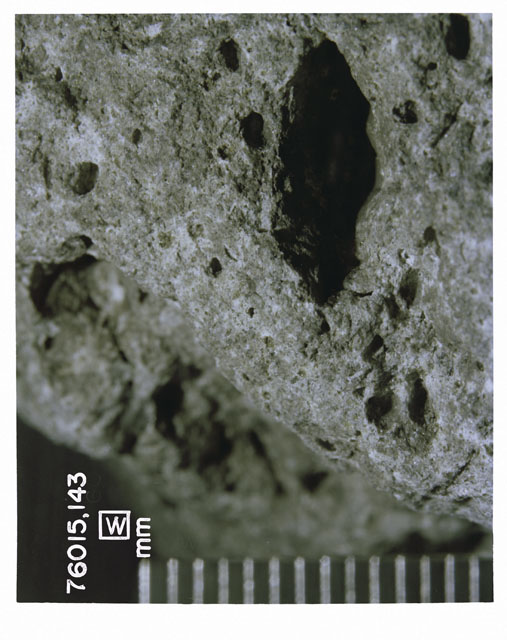 Color photograph of Apollo 17 Sample(s) 76015,143; Processing photograph displaying a close up view of the sample with an orientation of W.