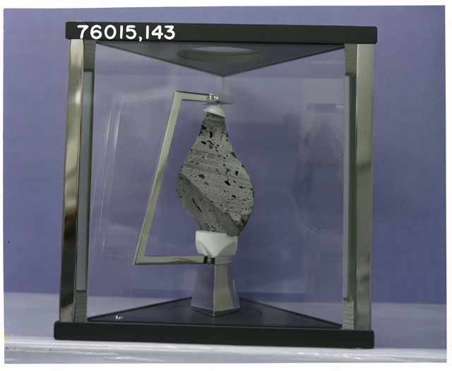 Color Processing photograph of Apollo 17 Sample(s) 76015,143 in a display case with a sawed surface face.