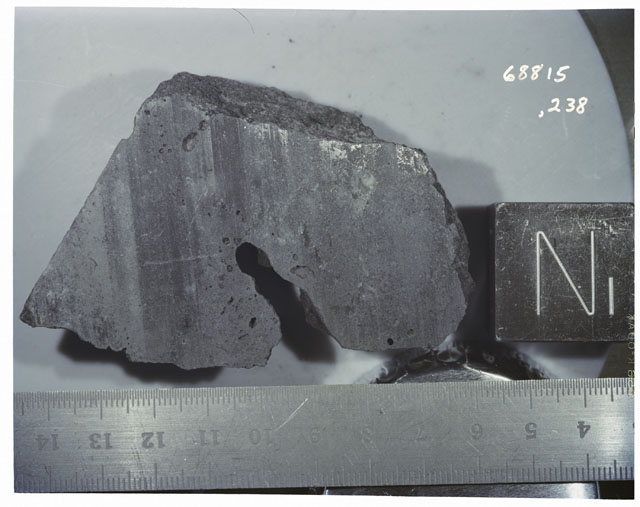 Color photograph of Apollo 16 Sample(s) 68815,238; Processing photograph displaying  with an sawed surface of N.