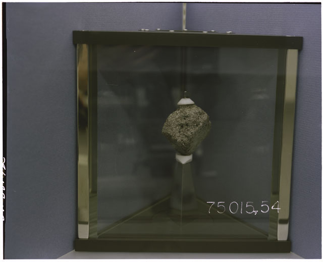 Color Processing photograph of Apollo 17 Sample(s) 75015,54 in a display case.