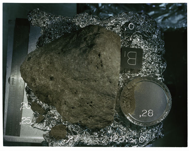 Color photograph of Apollo 12 Sample(S) 12016,0,28; Processing photograph displaying a post chip sample with fines and an orientation of B.