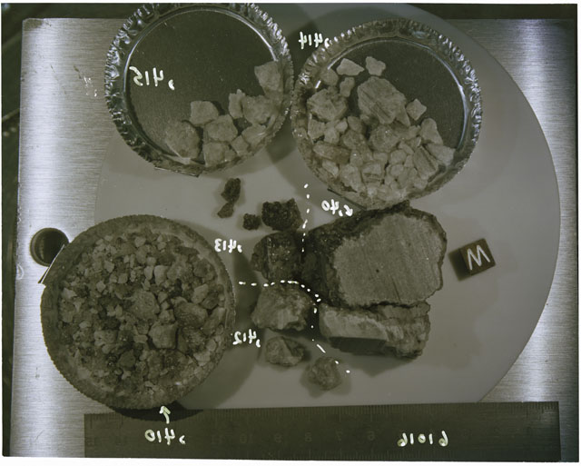 Color photograph of Apollo 16 Sample(s) 61016,40,410,412,413-,415; Processing photograph displaying chips and fragments with an orientation of W.