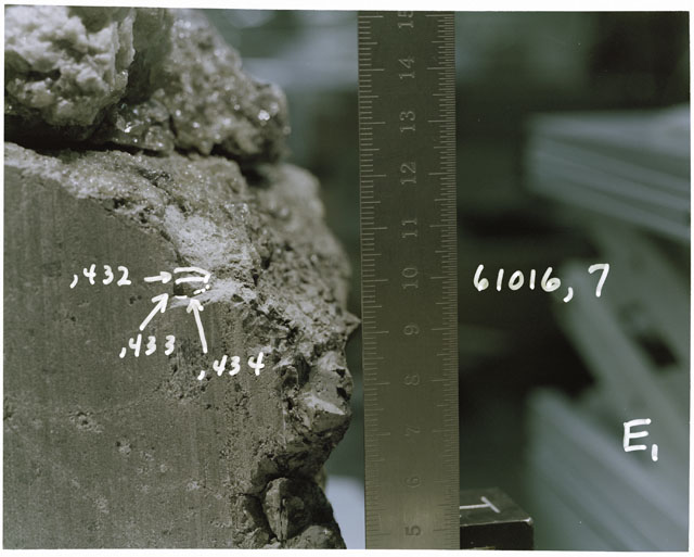 Color photograph of Apollo 16 Sample(s) 61016,7,432-,434; Processing photograph displaying sawed surface reconstruction with an orientation of E.