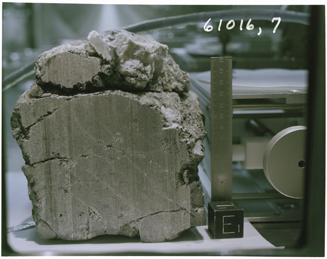 Color photograph of Apollo 16 Sample(s) 61016,7; Processing photograph displaying sawed surface reconstruction with an orientation of E,T.