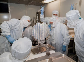 Scientists examine the aerogel tray after its arrival at JSC